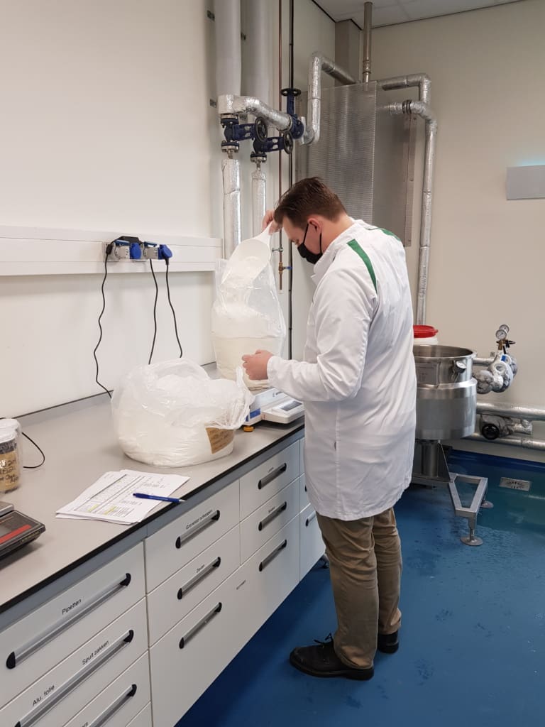 Process technologist preparing ingredients during on-site training with Vomatec pilot system